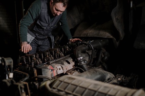 Technician working on a heavy-duty diesel engine