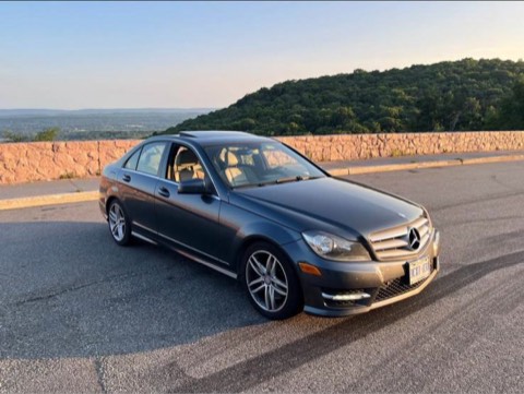Grey Mercedes-Benz C300 photographed at sunset