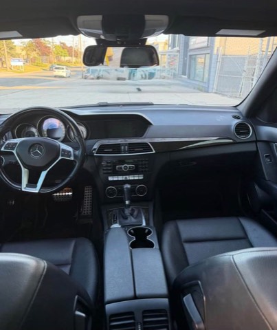 Wide view of the dashboard of a previously sourced white Mercedes-Benz C300
